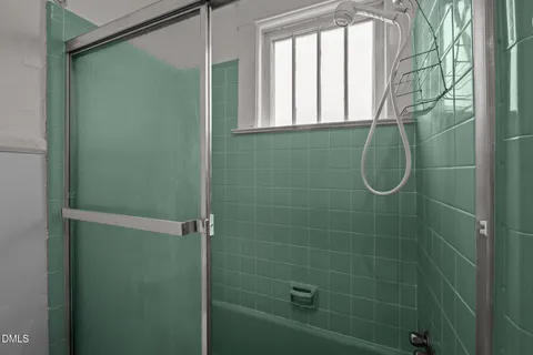 a bathroom with a glass shower door