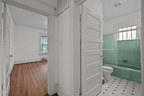 a bathroom with a toilet and a shower