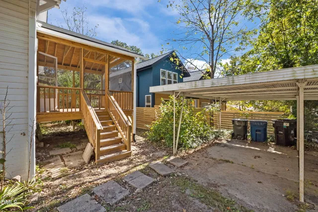 a view of a house with a patio and a yard