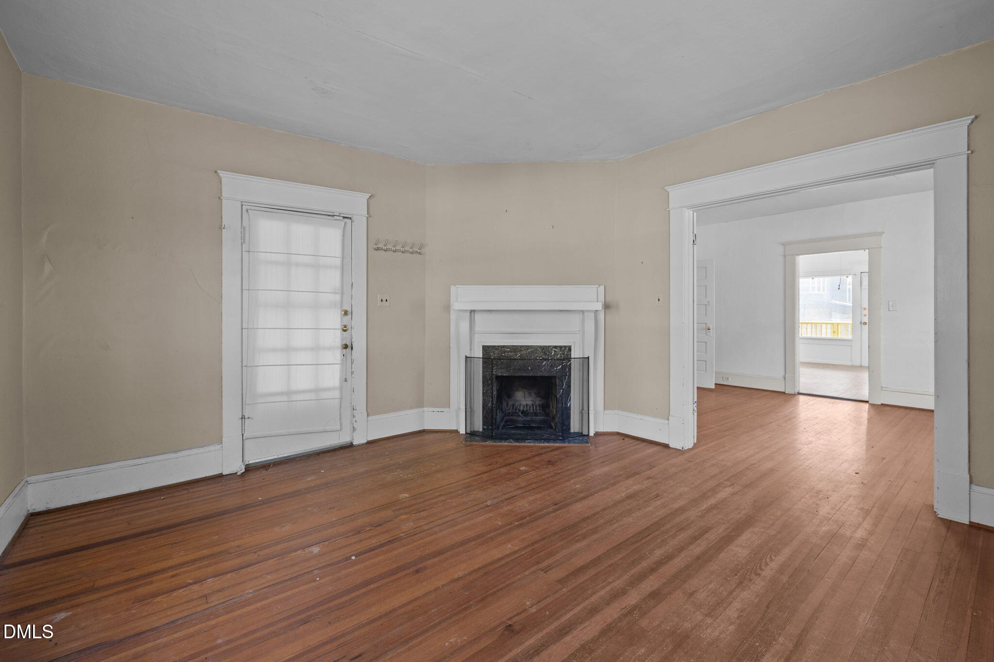 303 Clark Street Durham, NC 27701 - Photo 8 of 30 an empty room with wooden floor fireplace and windows