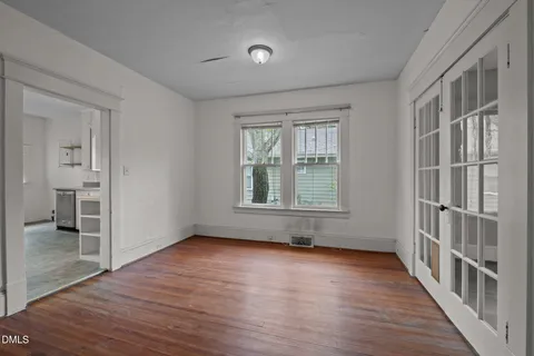 wooden floor in an empty room with a window
