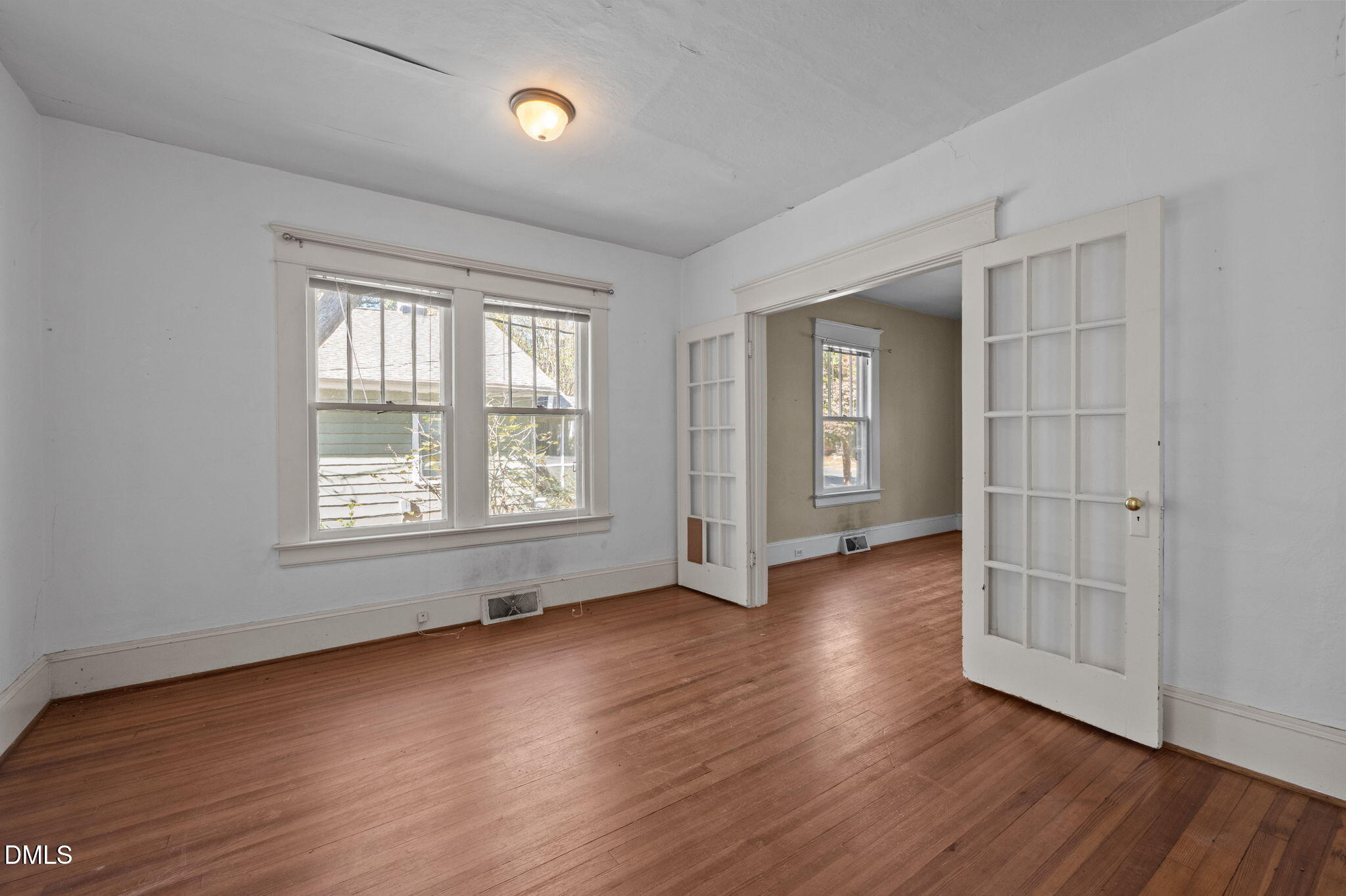 303 Clark Street Durham, NC 27701 - Photo 10 of 30 an empty room with wooden floor and windows