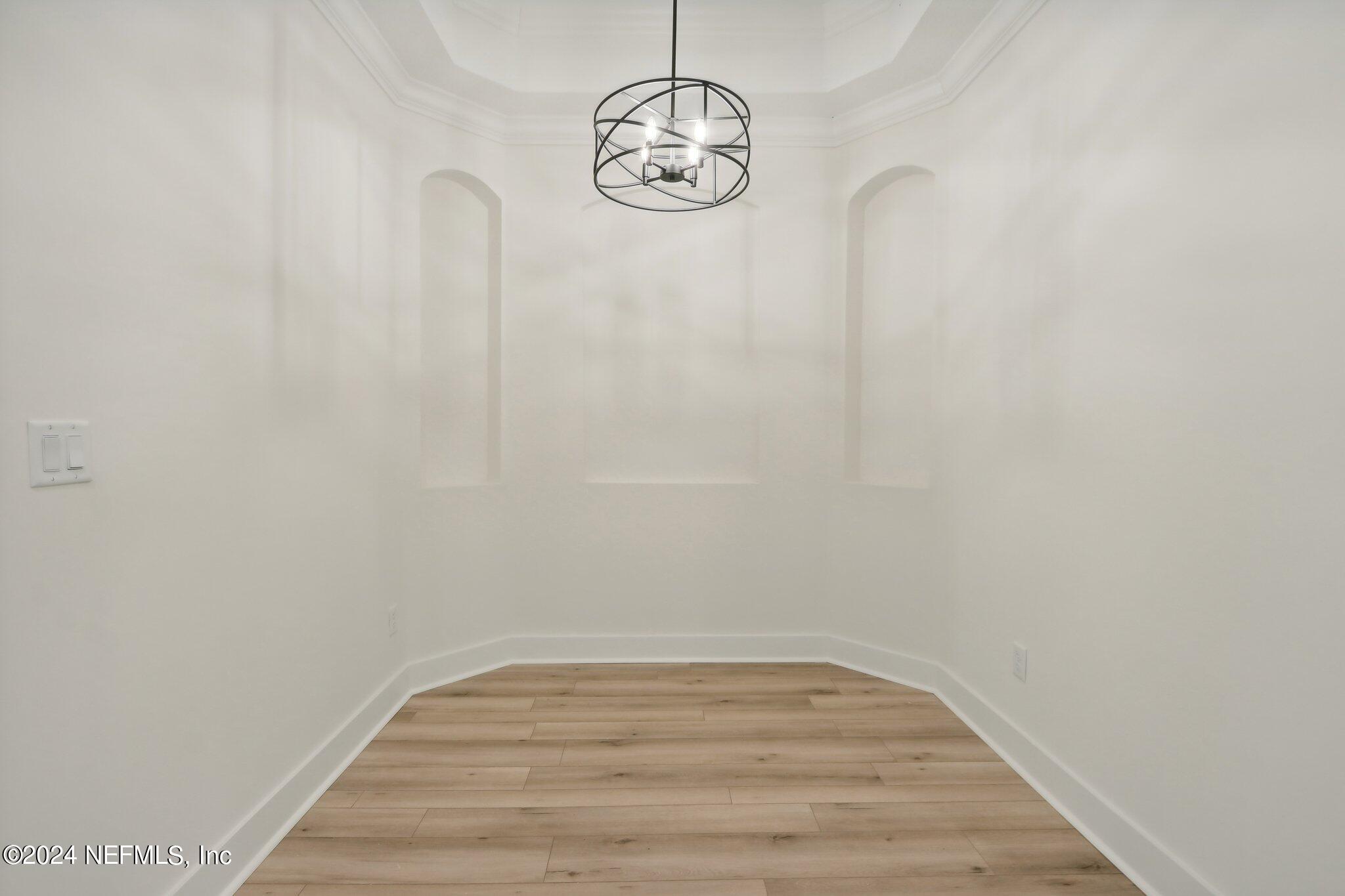 156 Cacique Drive St. Augustine, FL 32086 - Photo 12 of 68 a view of a room with wooden floor and white walls