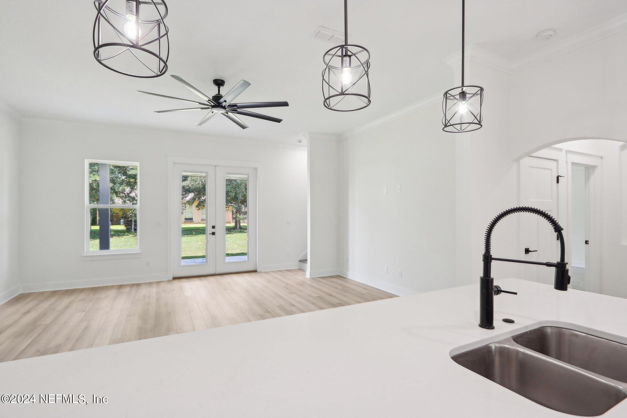 156 Cacique Drive St. Augustine, FL 32086 - Photo 14 of 68 a view of a kitchen with a sink cabinetry a chandelier and fireplace