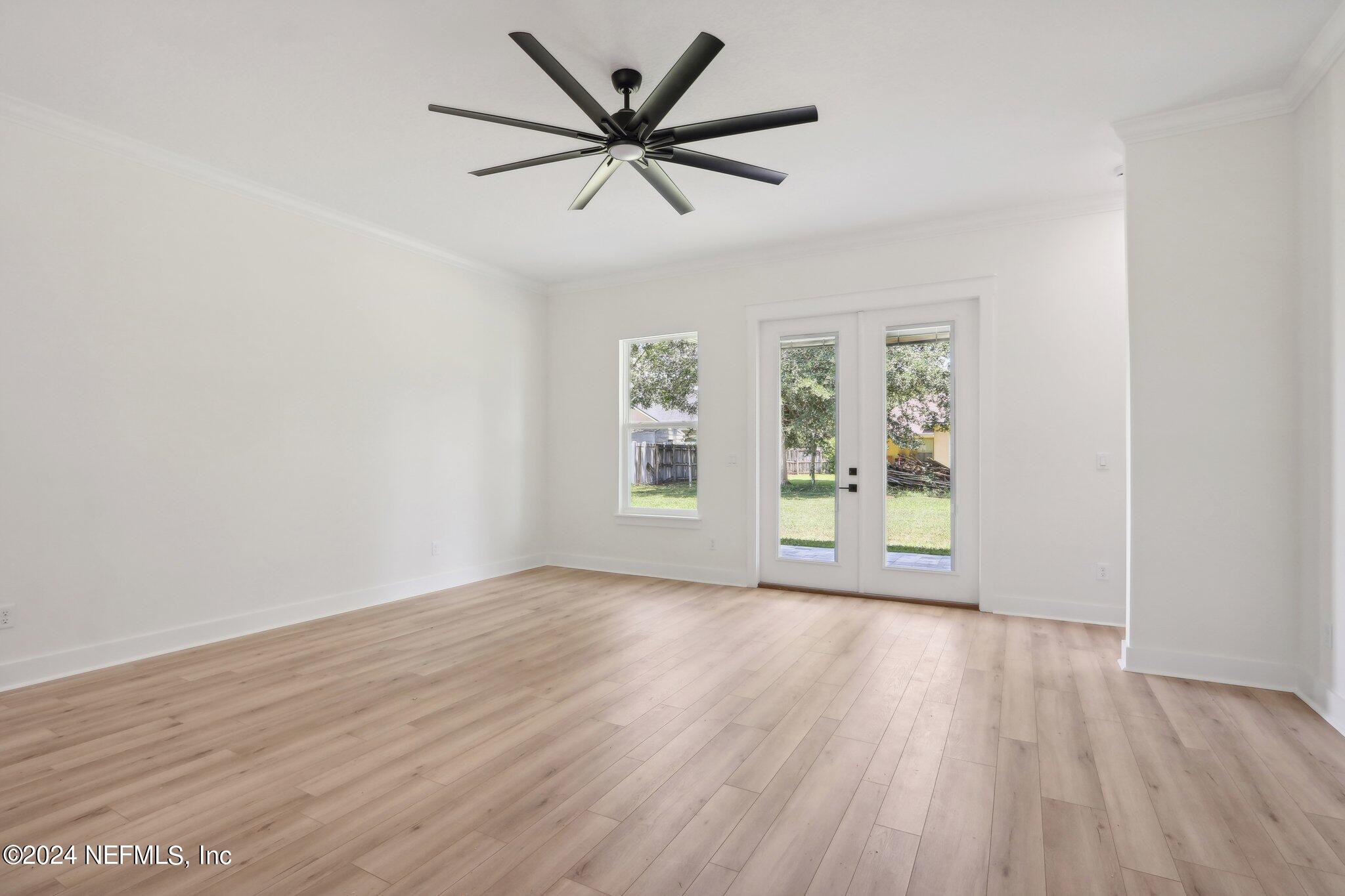 156 Cacique Drive St. Augustine, FL 32086 - Photo 16 of 68 wooden floor in an empty room with a window
