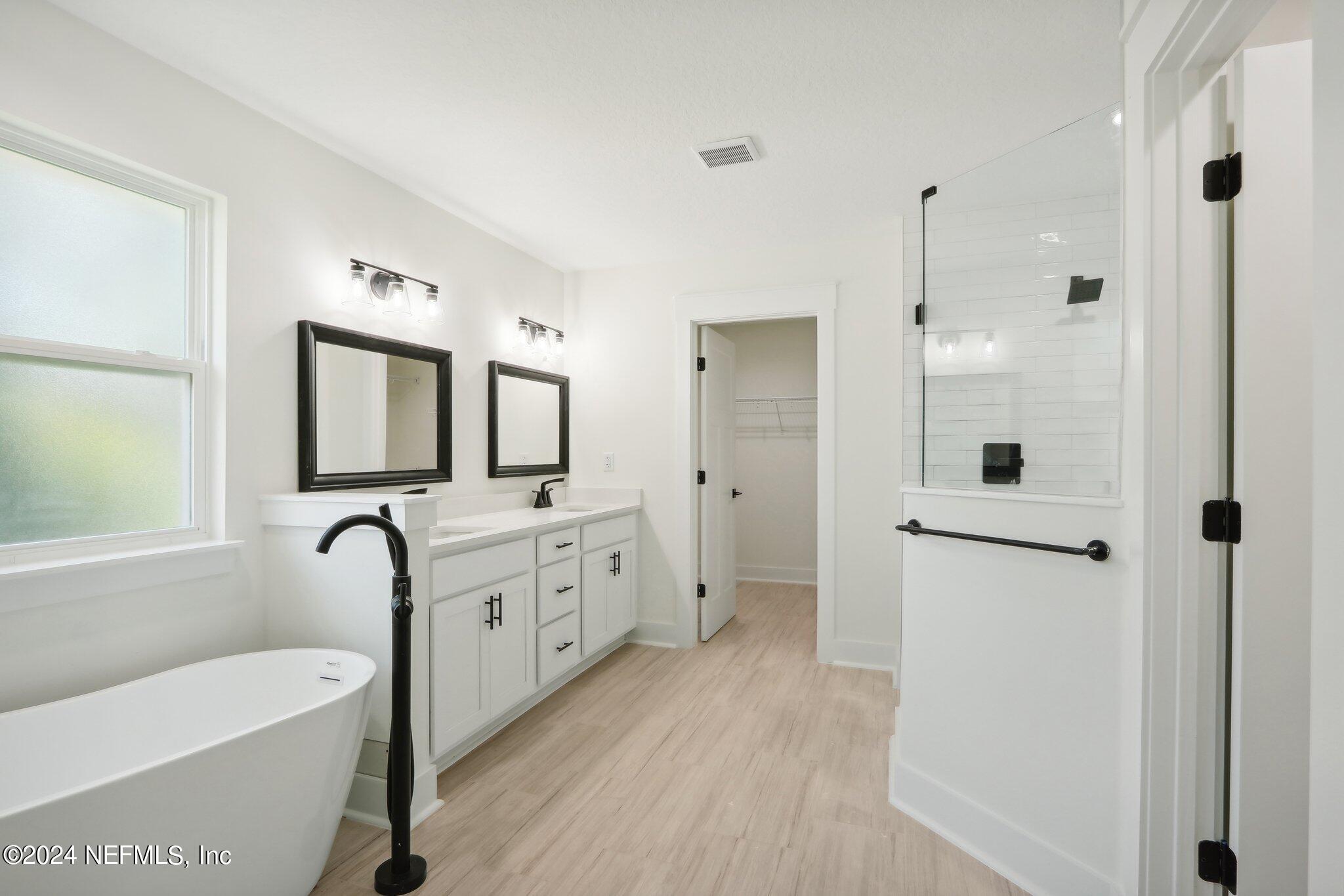 156 Cacique Drive St. Augustine, FL 32086 - Photo 21 of 68 a bathroom with a double vanity sink mirror bathtub and shower