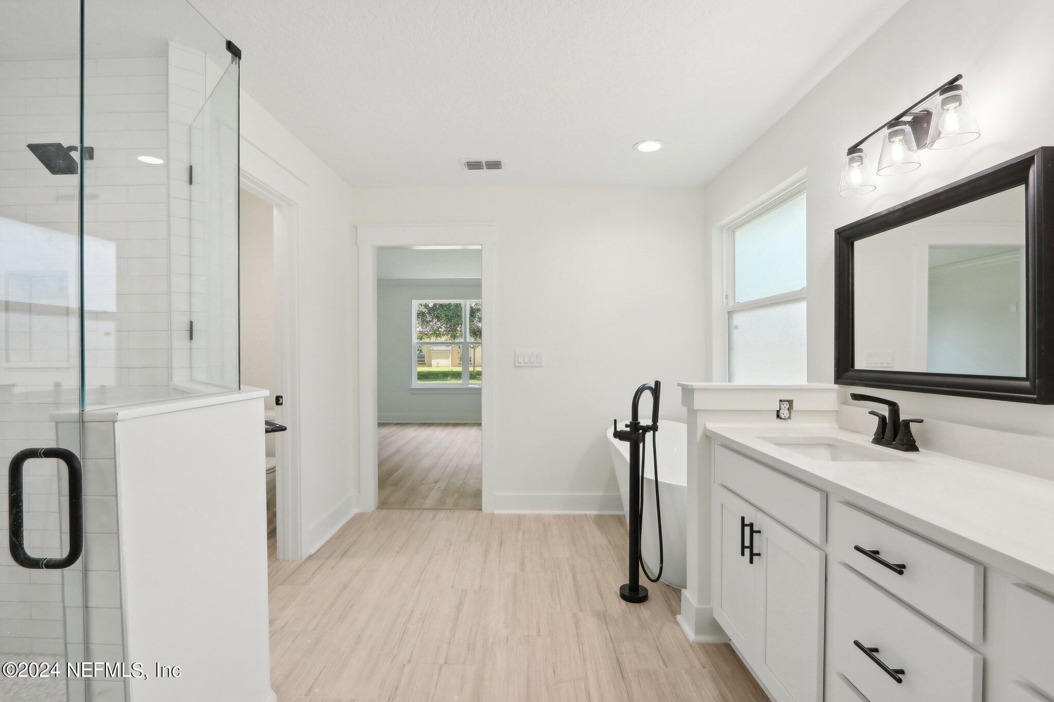 156 Cacique Drive St. Augustine, FL 32086 - Photo 22 of 68 a bathroom with a double vanity sink a mirror and shower