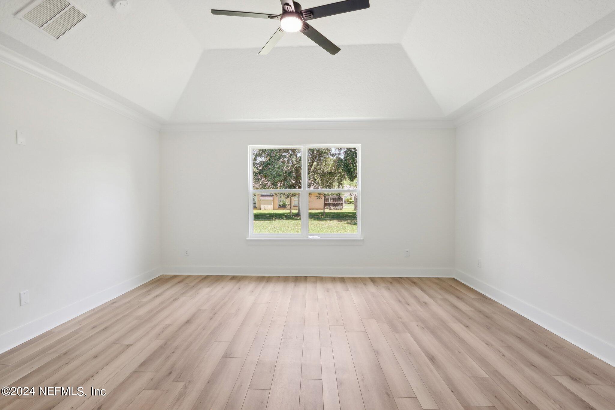 156 Cacique Drive St. Augustine, FL 32086 - Photo 25 of 68 an empty room with wooden floor and windows