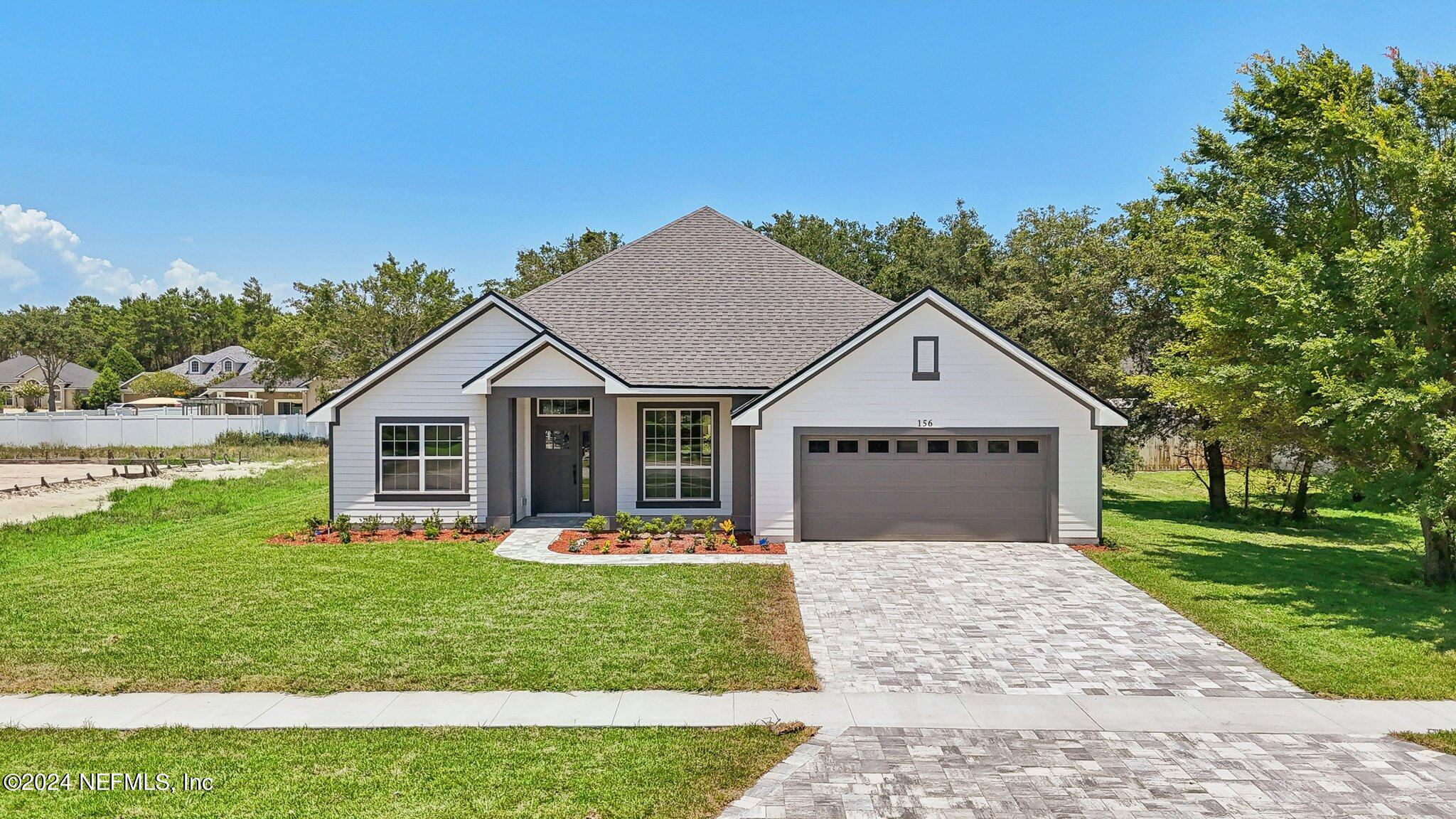 156 Cacique Drive St. Augustine, FL 32086 - Photo 3 of 68 a front view of a house with a yard and garage