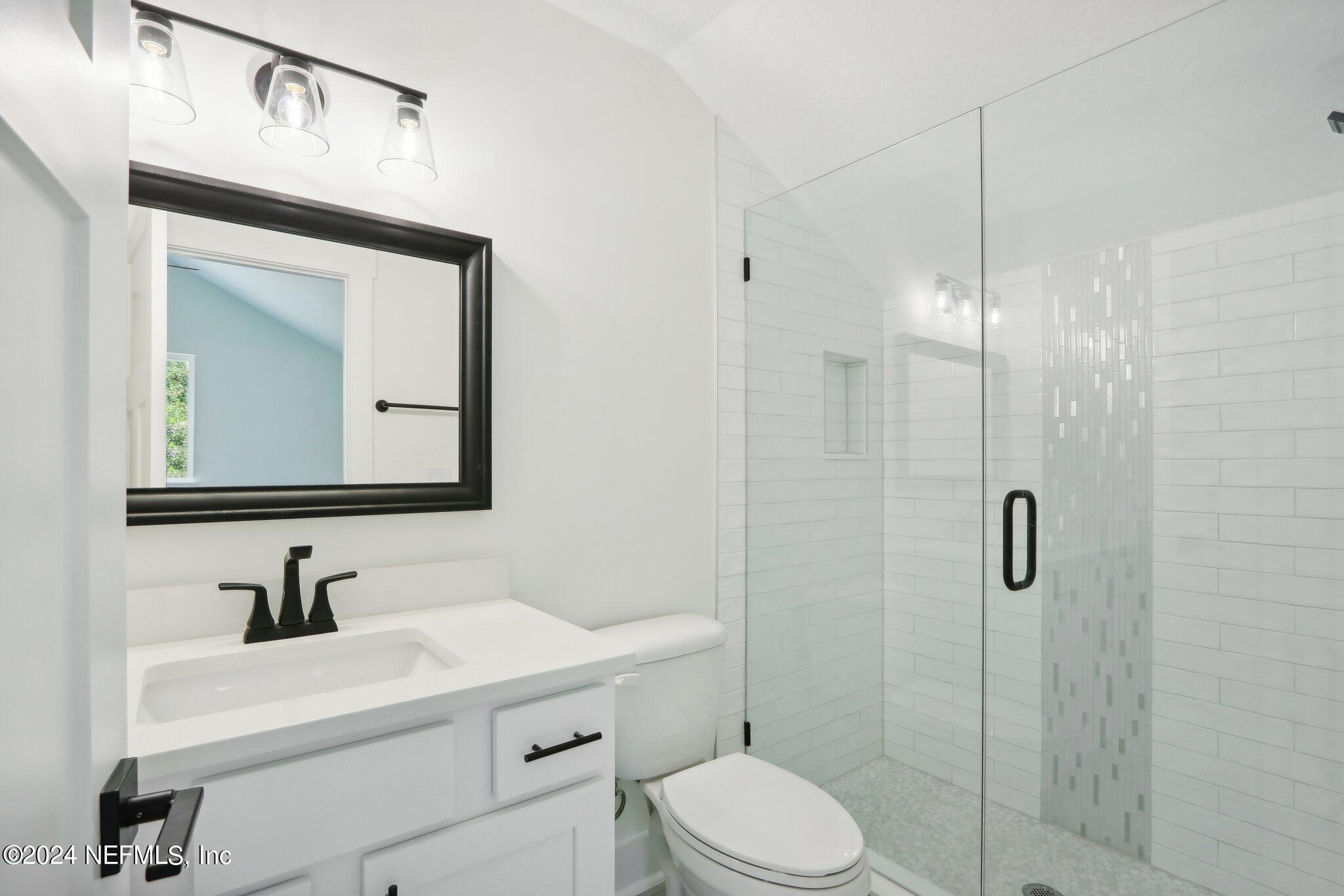 156 Cacique Drive St. Augustine, FL 32086 - Photo 33 of 68 a bathroom with a sink a toilet and shower