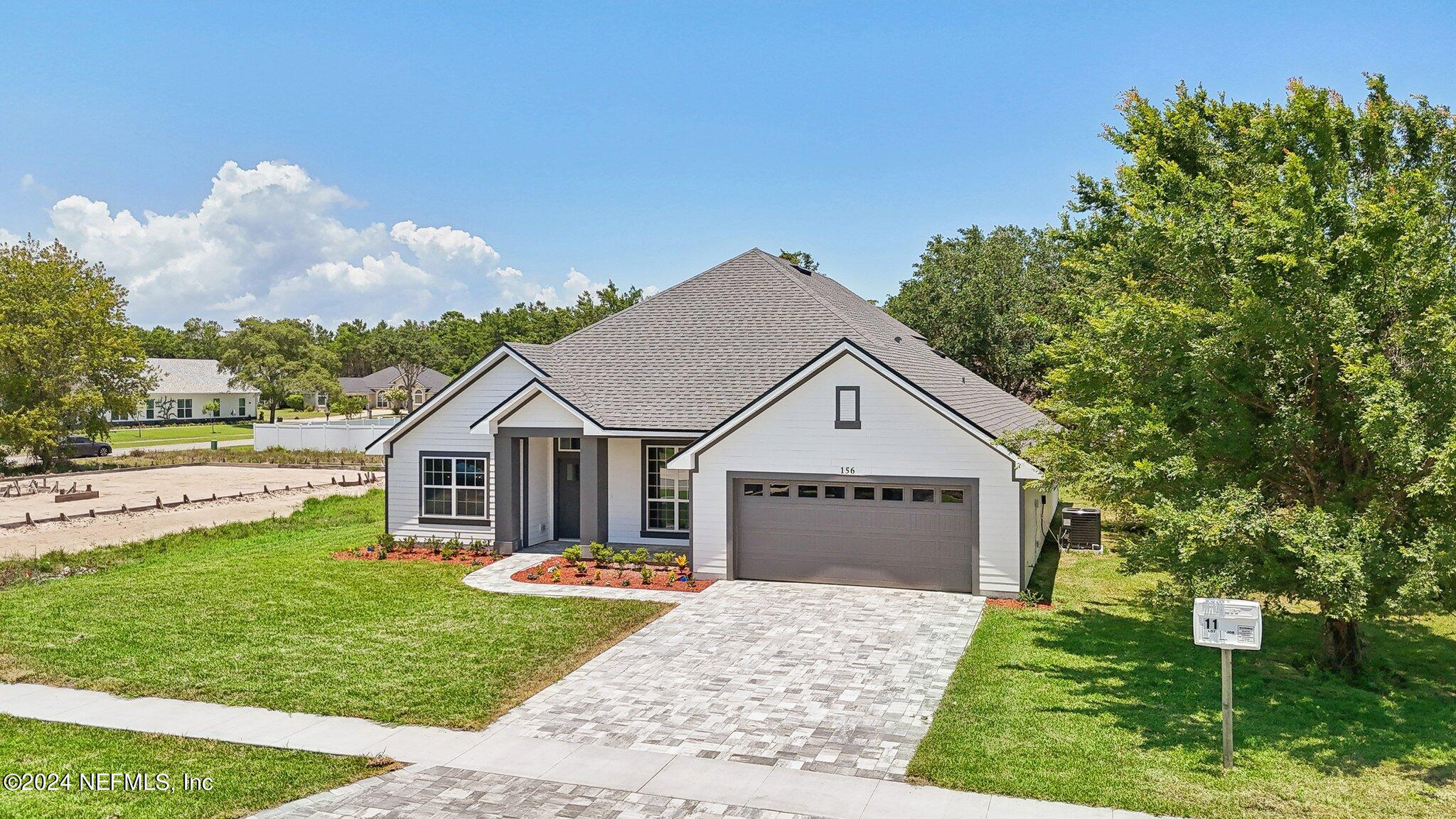 156 Cacique Drive St. Augustine, FL 32086 - Photo 41 of 68 a view of a house with a yard and large tree