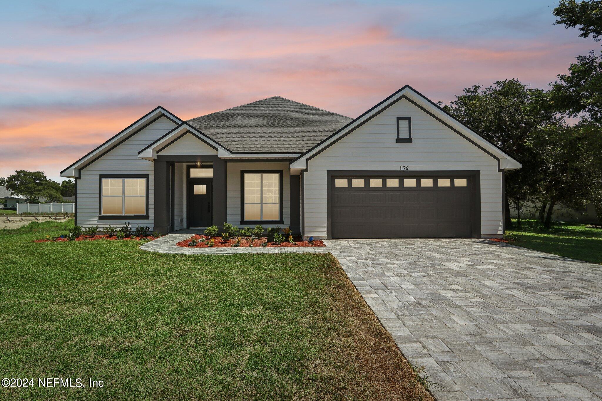 156 Cacique Drive St. Augustine, FL 32086 - Photo 42 of 68 a front view of a house with yard and green space