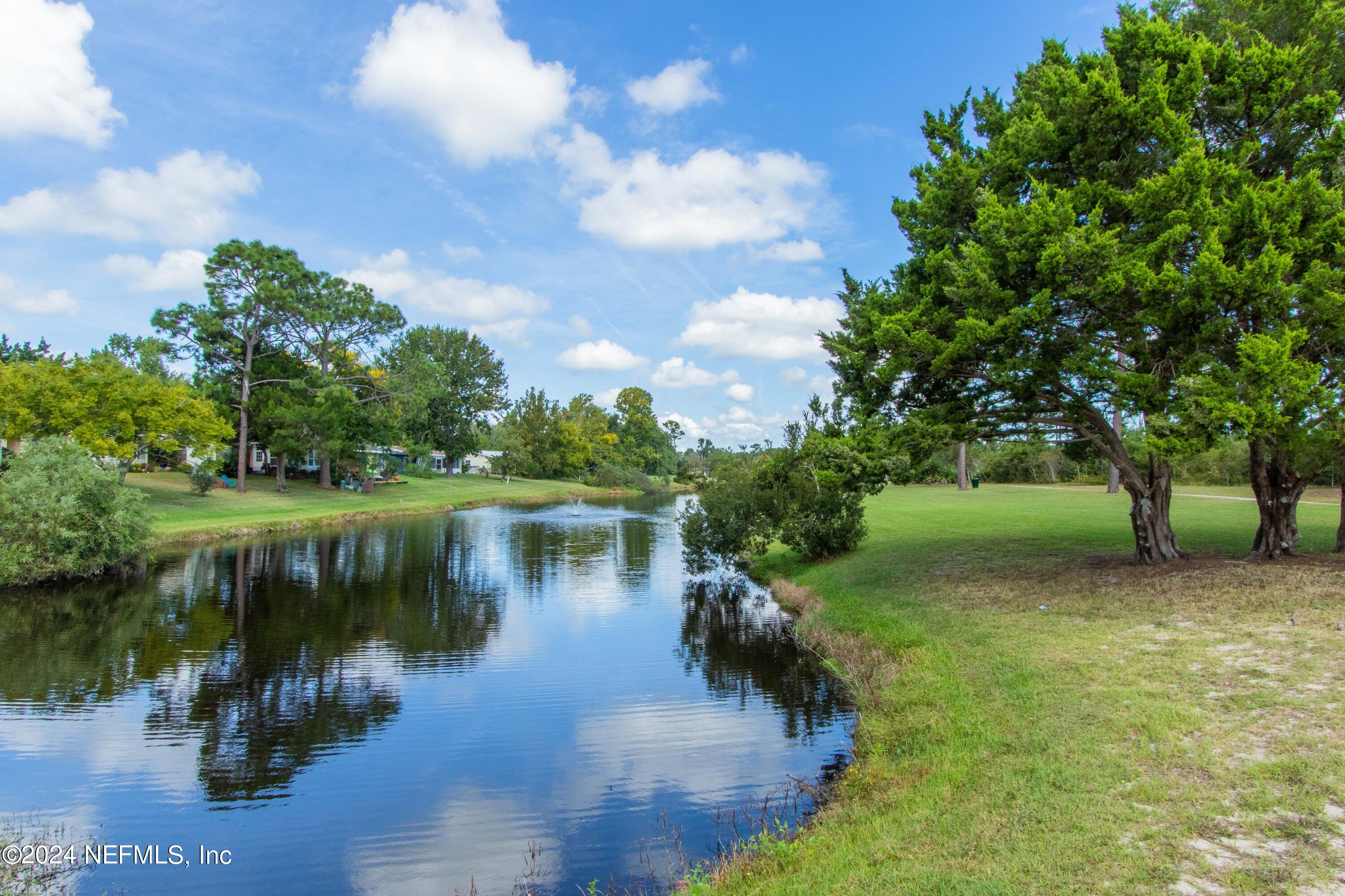 156 Cacique Drive St. Augustine, FL 32086 - Photo 60 of 68 a view of a lake with a yard