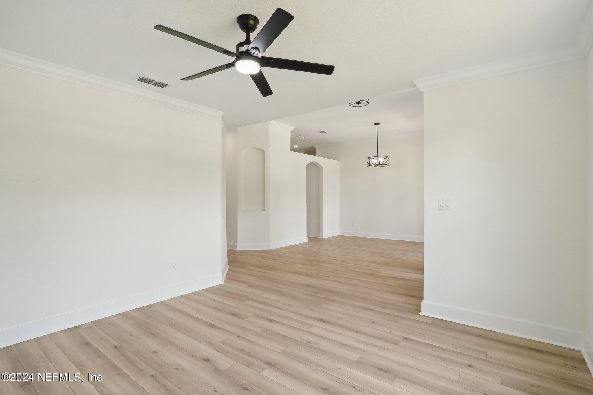 156 Cacique Drive St. Augustine, FL 32086 - Photo 8 of 68 a view of empty room with wooden floor