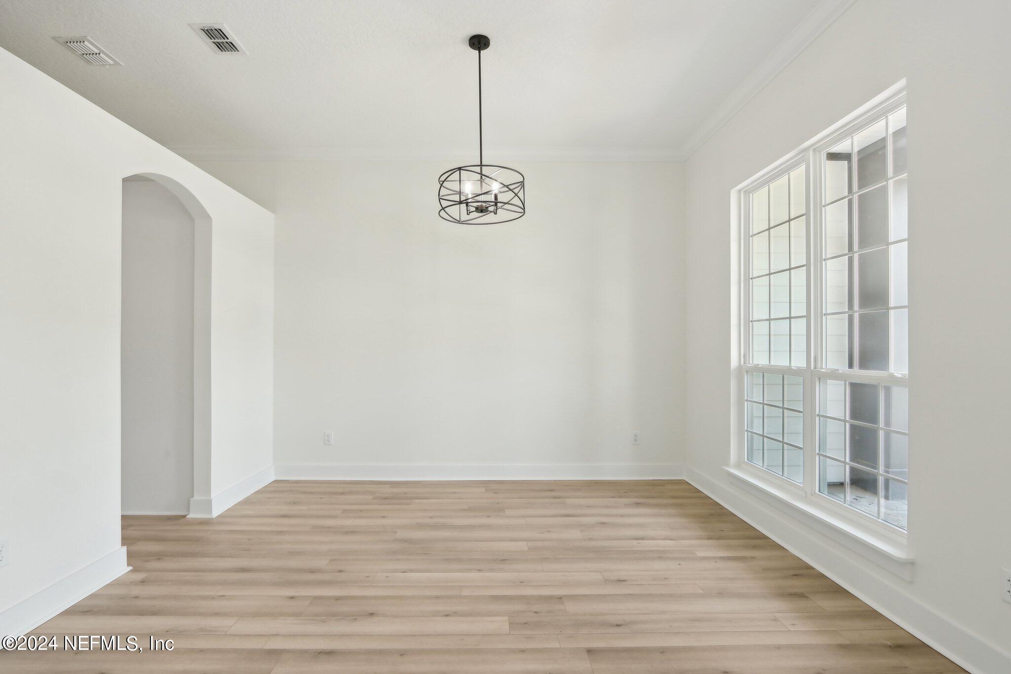 156 Cacique Drive St. Augustine, FL 32086 - Photo 10 of 68 a view of room with window and wooden floor
