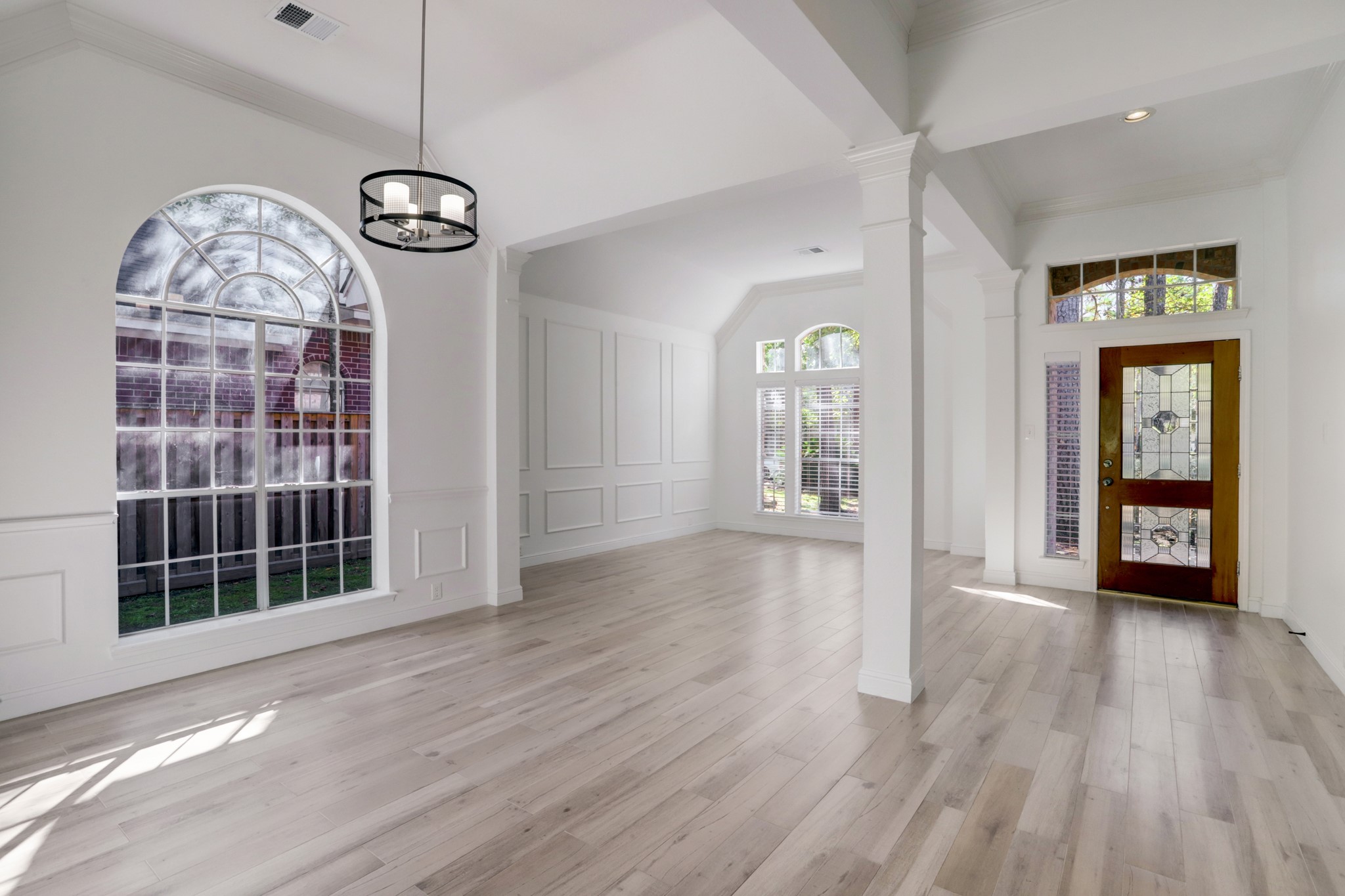 138 Summer Storm Place Spring, TX 77381 - Photo 3 of 20 An open, airy entry connects the formal living and dining spaces beneath soaring ceilings.