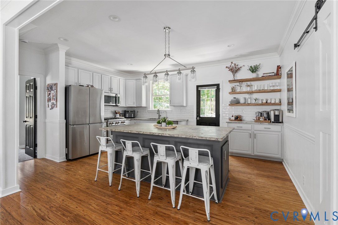 1755 Dispatch Road Quinton, VA 23141 - Photo 20 of 86 a kitchen with granite countertop a refrigerator a stove a sink dishwasher a dining table and chairs with wooden floor