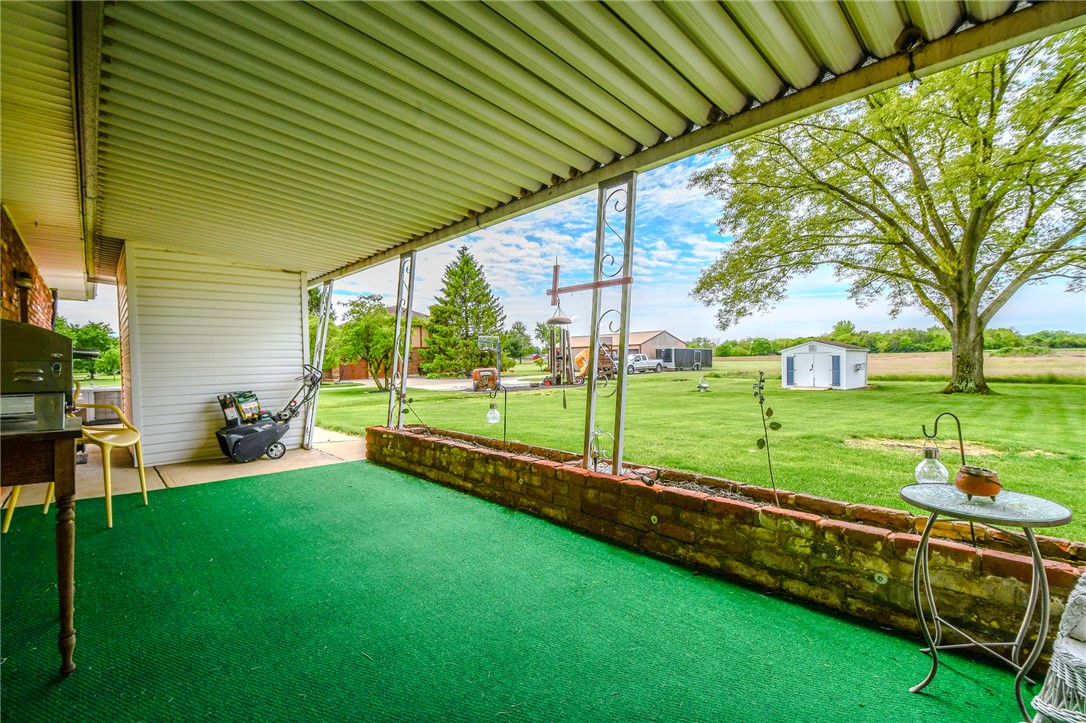 10833 Kendig Road Medway, OH 45341 - Photo 41 of 46 Enjoy tranquil views of the sprawling yard from this inviting covered patio.
