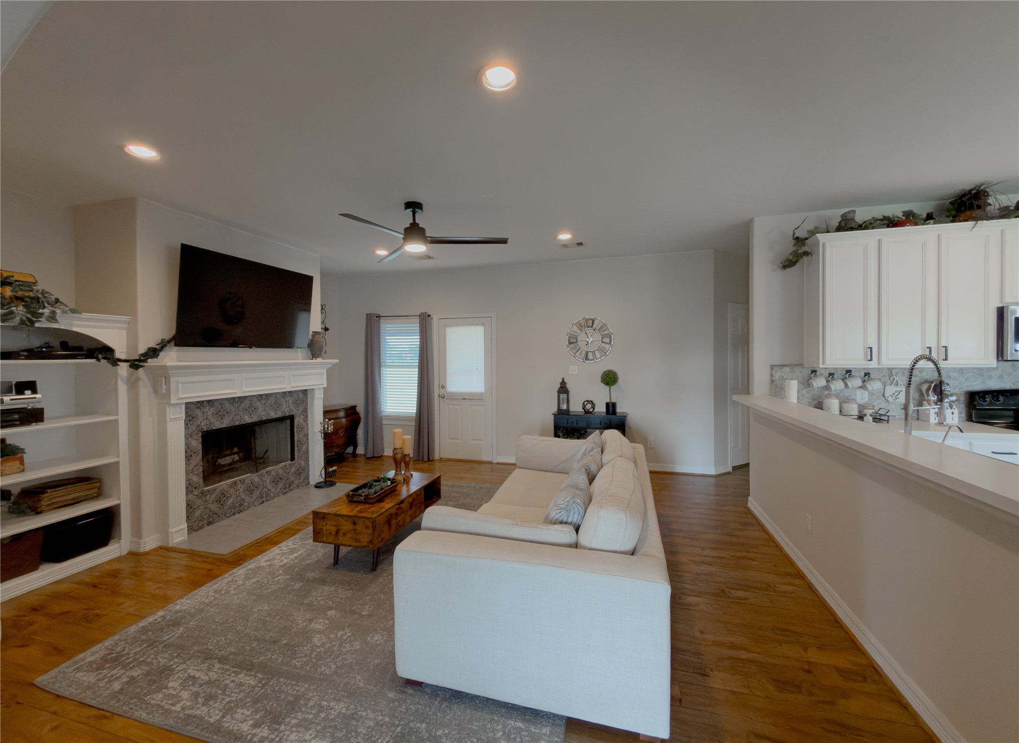 14302 Austin Bayou Drive Rosharon, TX 77583 - Photo 2 of 22 a living room with furniture a fireplace and a flat screen tv
