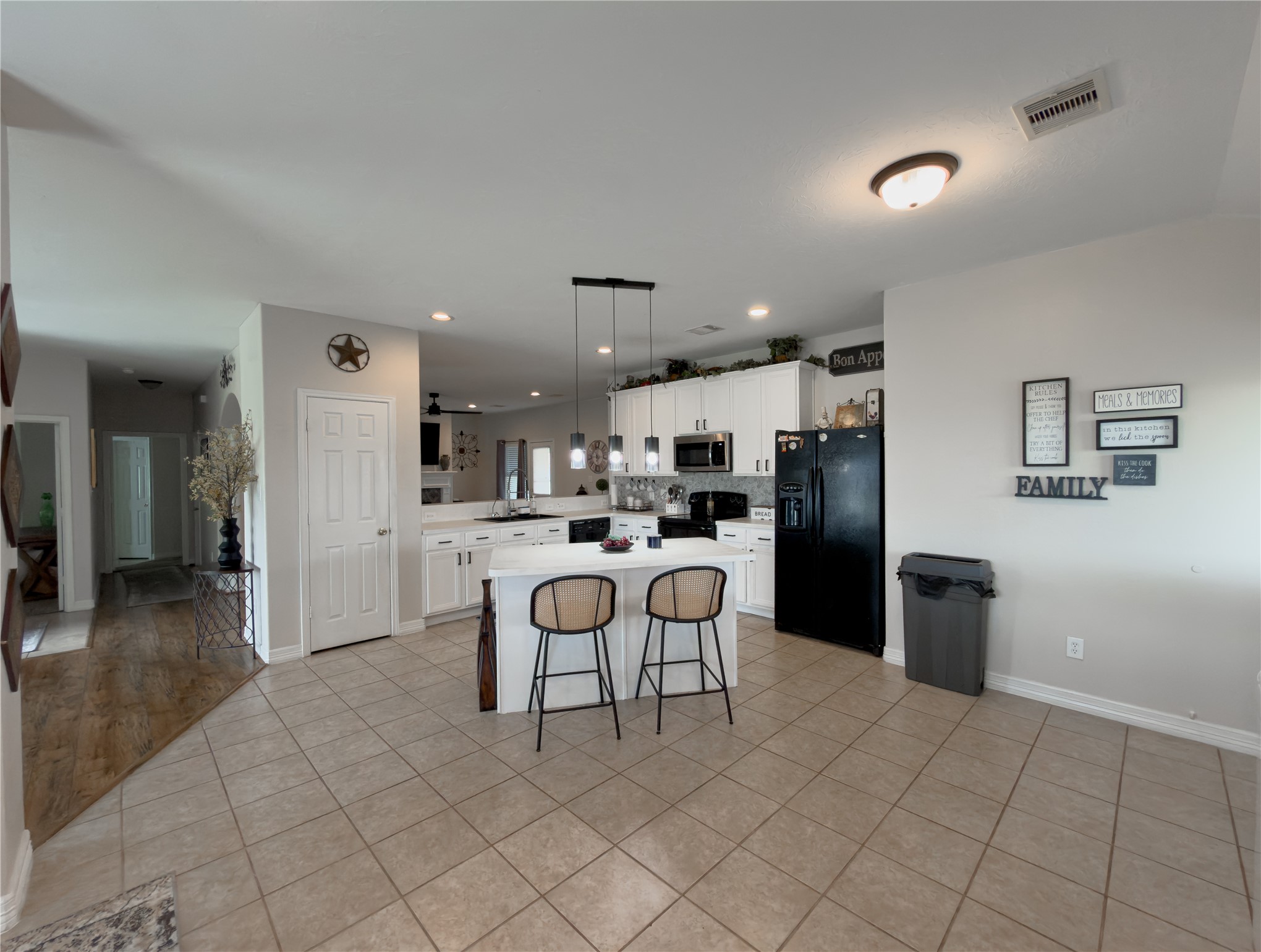 14302 Austin Bayou Drive Rosharon, TX 77583 - Photo 6 of 22 a kitchen with stainless steel appliances kitchen island granite countertop a refrigerator and a sink