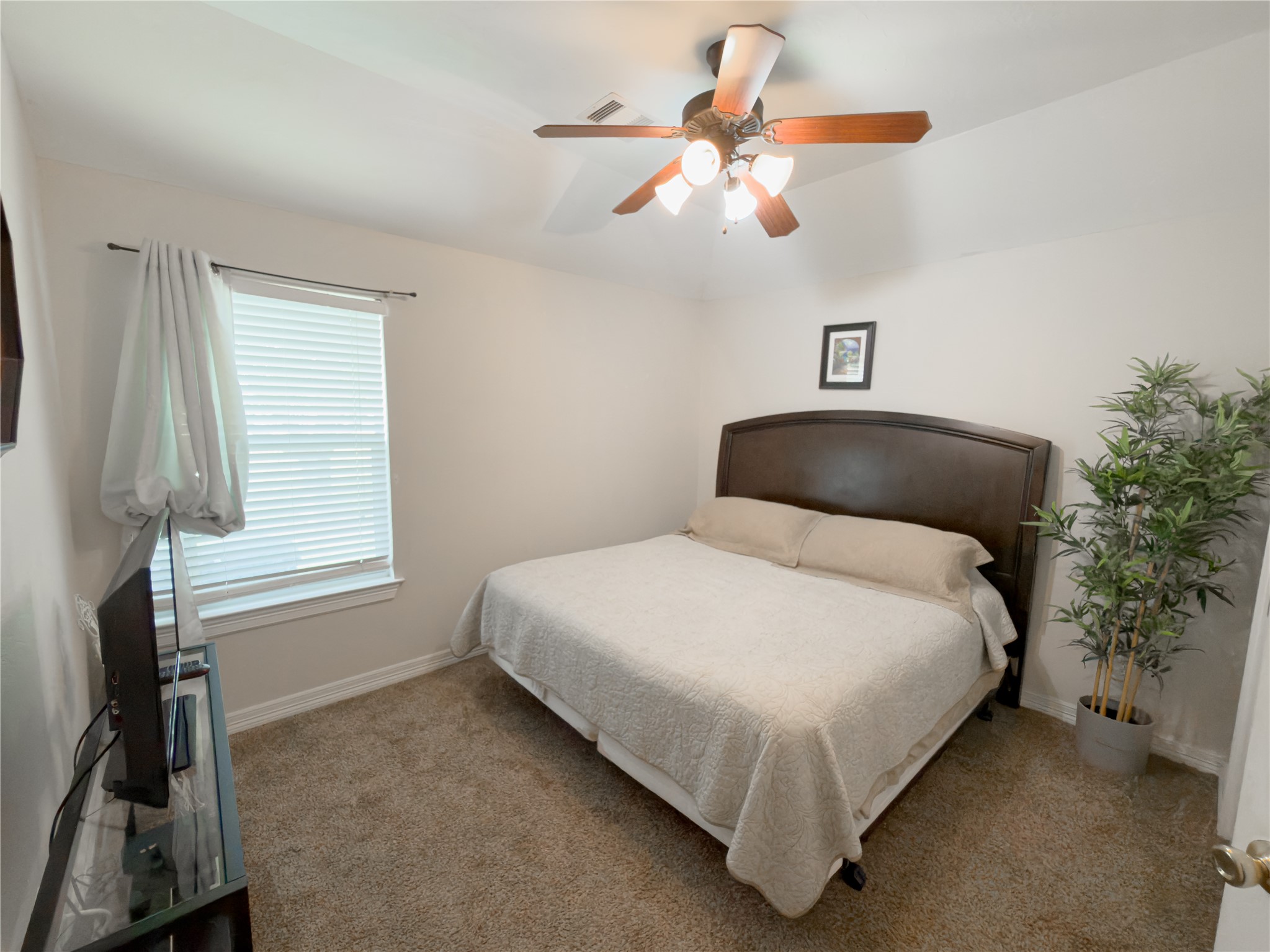 14302 Austin Bayou Drive Rosharon, TX 77583 - Photo 10 of 22 a bedroom with a bed and a chandelier