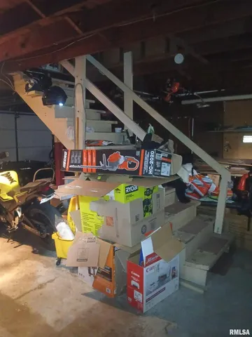 a living room with furniture gym equipment and a large window