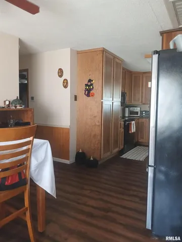 a kitchen with stainless steel appliances granite countertop a refrigerator and a stove