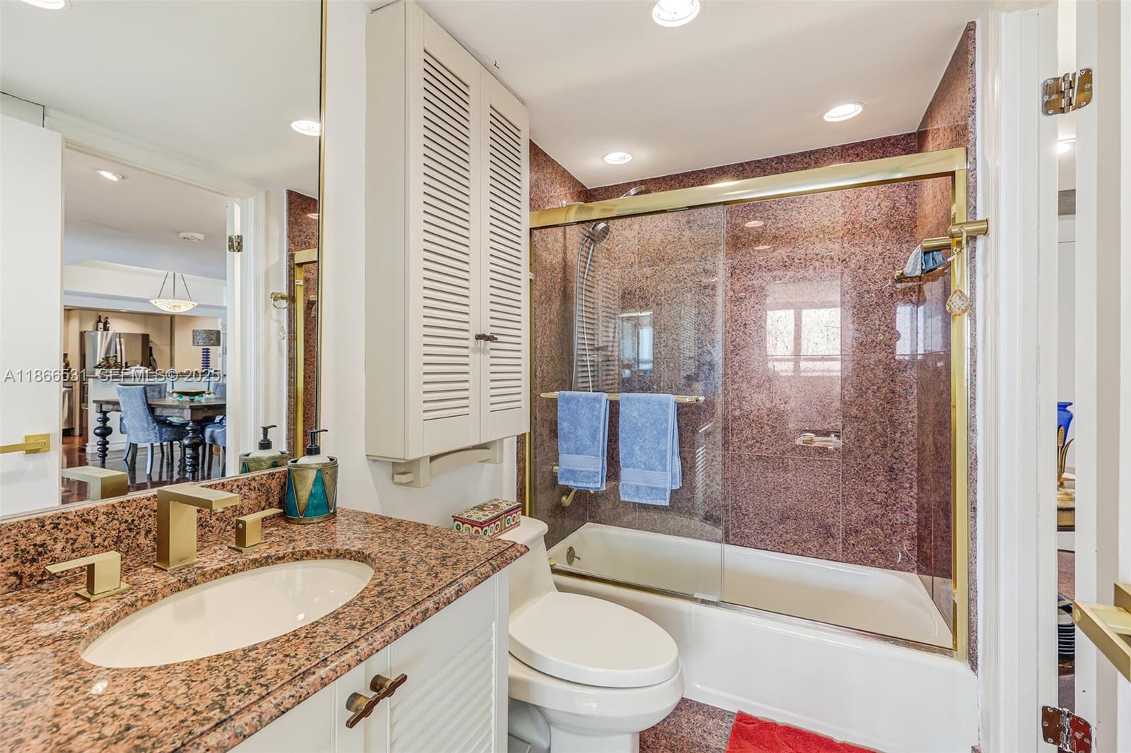 2 Grove Isle Drive, Unit B1603 Miami, FL 33133 - Photo 11 of 20 a bathroom with a granite countertop sink toilet mirror and shower