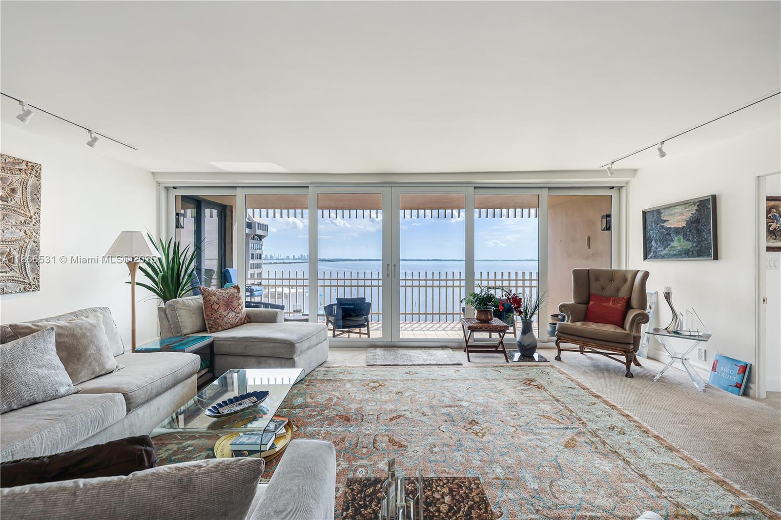 2 Grove Isle Drive, Unit B1603 Miami, FL 33133 - Photo 2 of 20 a living room with furniture and a large window