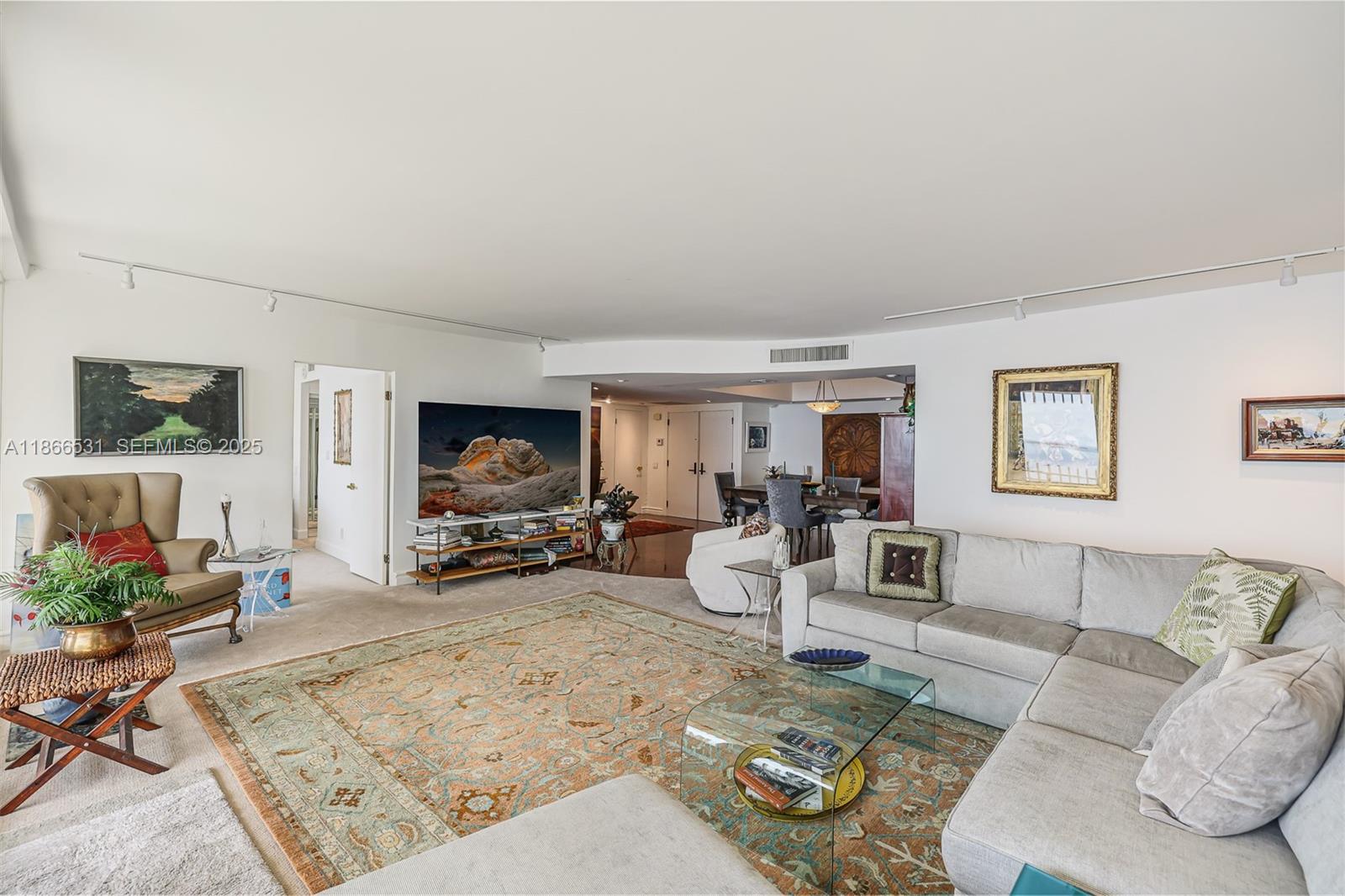 2 Grove Isle Drive, Unit B1603 Miami, FL 33133 - Photo 3 of 20 a living room with furniture and a flat screen tv