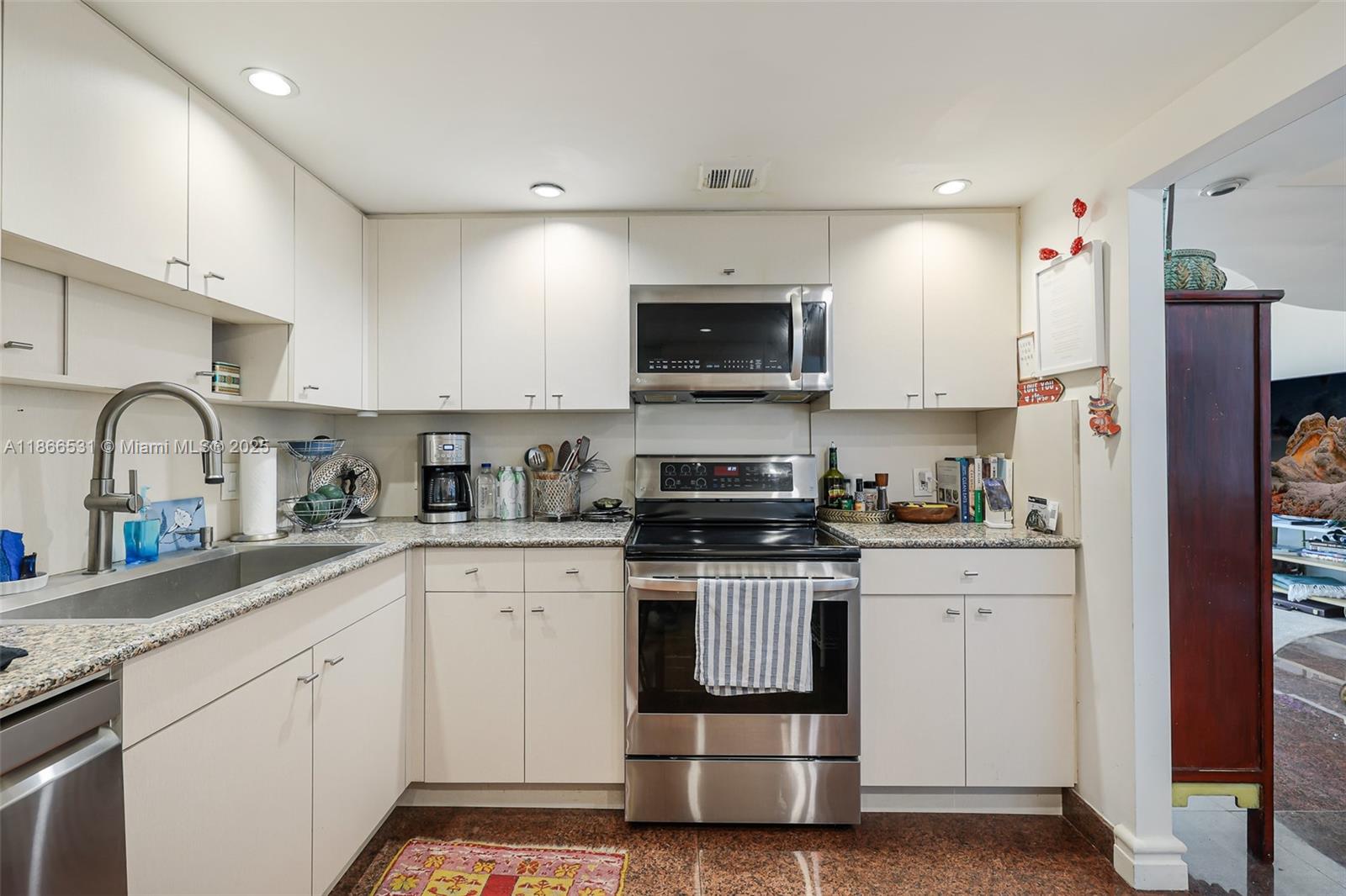 2 Grove Isle Drive, Unit B1603 Miami, FL 33133 - Photo 4 of 20 a kitchen with stainless steel appliances granite countertop a stove a sink and a refrigerator