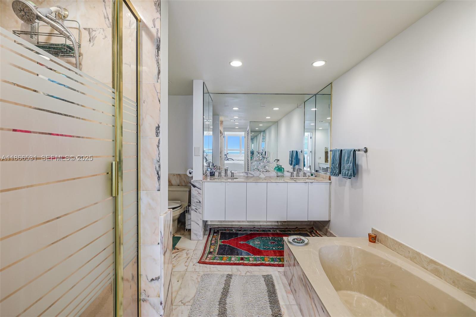 2 Grove Isle Drive, Unit B1603 Miami, FL 33133 - Photo 9 of 20 a bathroom with mirror and shower