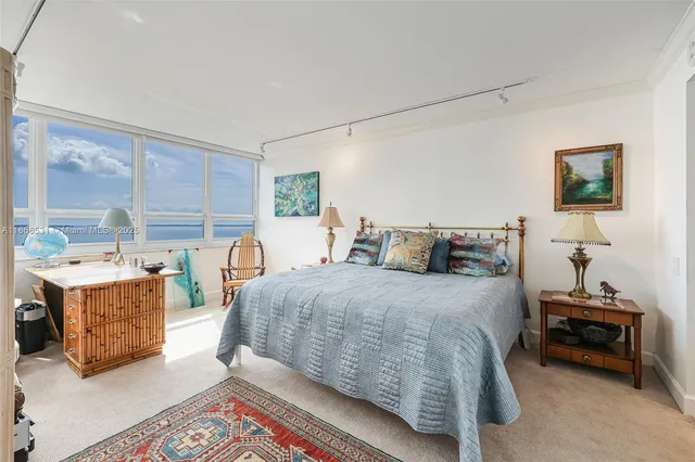 a bathroom with a granite countertop sink toilet mirror and shower