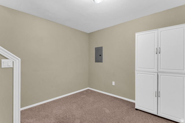 14108 Pepi Band Road Draper, UT 84020 - Photo 27 of 36 Integrated white storage cabinetry with brushed nickel hardware, neutral-toned walls, and brown carpeting