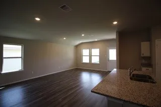 a view of a kitchen island wooden floor and a sink