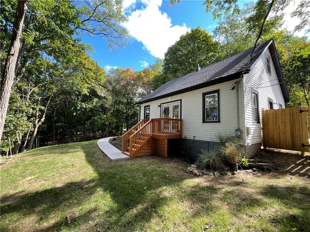39 Lake Road Valley Cottage, NY 10989 - Photo 1 of 1 a front view of house with yard and trees in the background
