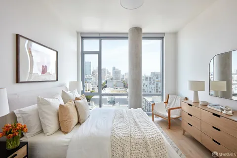 a bedroom with furniture and a large window