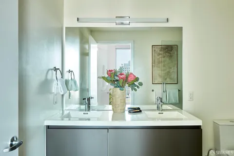 a bathroom with a double vanity sink and a mirror