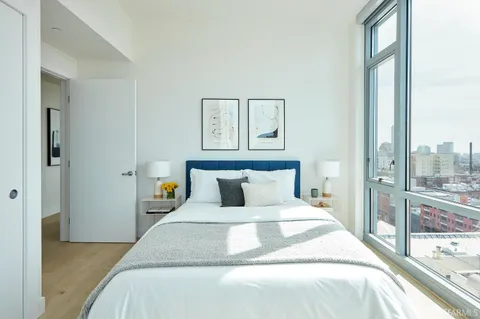 a bedroom with a large bed and a large mirror