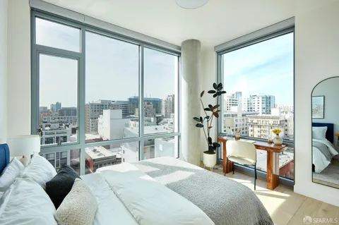 a bedroom with furniture and a large window