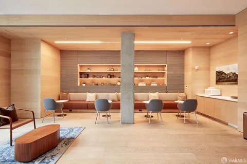 a living room with furniture and floor to ceiling windows