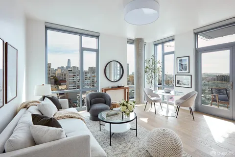 a living room with furniture a table and a large window