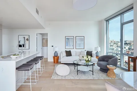 a living room with furniture a table and large window