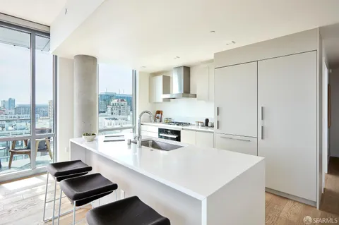 a kitchen with stainless steel appliances a sink a stove and a refrigerator