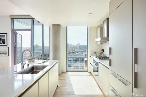 a kitchen with stainless steel appliances a sink a stove and a window