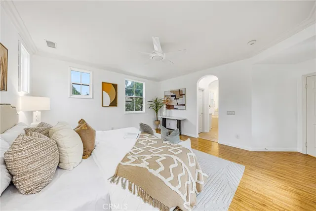 a bedroom with furniture and a wooden floor