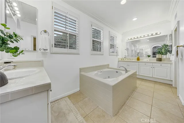 a bathroom with a sink a bathtub a mirror and vanity