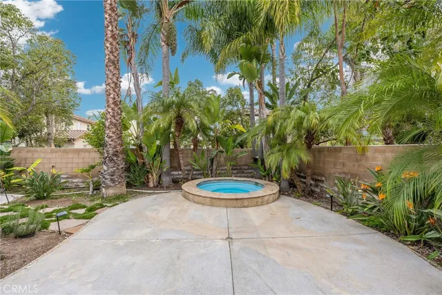 a backyard of a house with a basket ball court