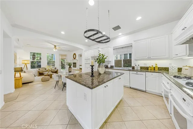 a kitchen with stainless steel appliances granite countertop a sink and cabinets