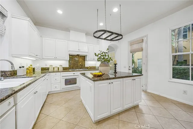 a kitchen with cabinets and window
